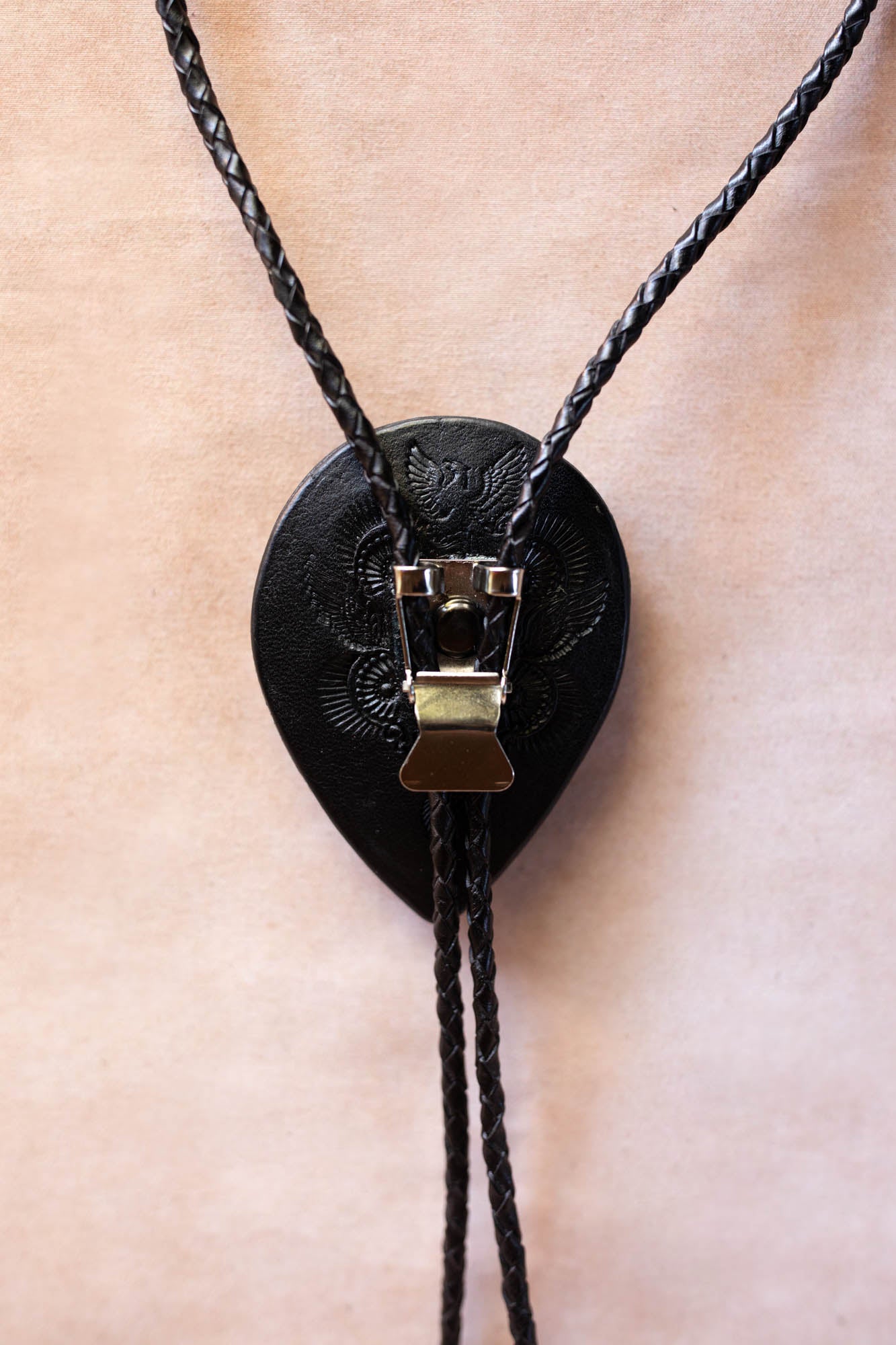 Black leather bolo tie with metal clasp