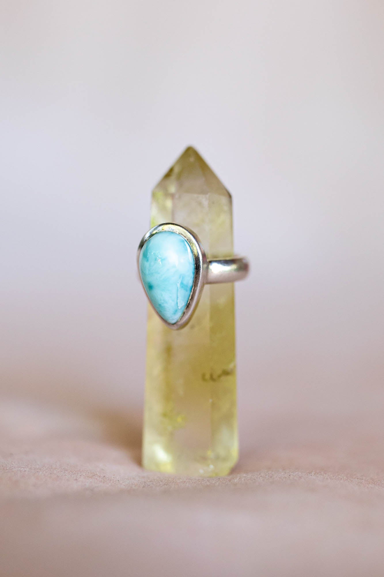 Ring with a blue gemstone on a clear crystal base