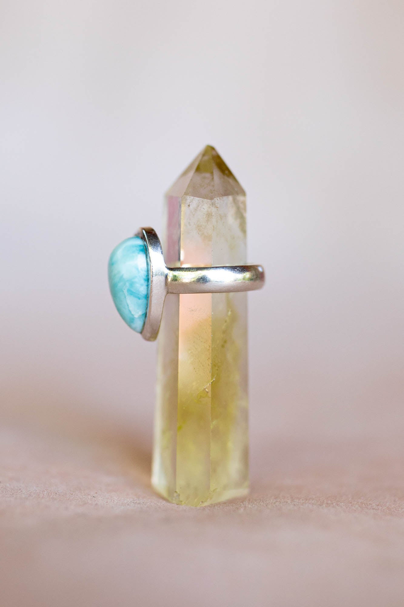 Silver ring with a blue gemstone on a clear crystal