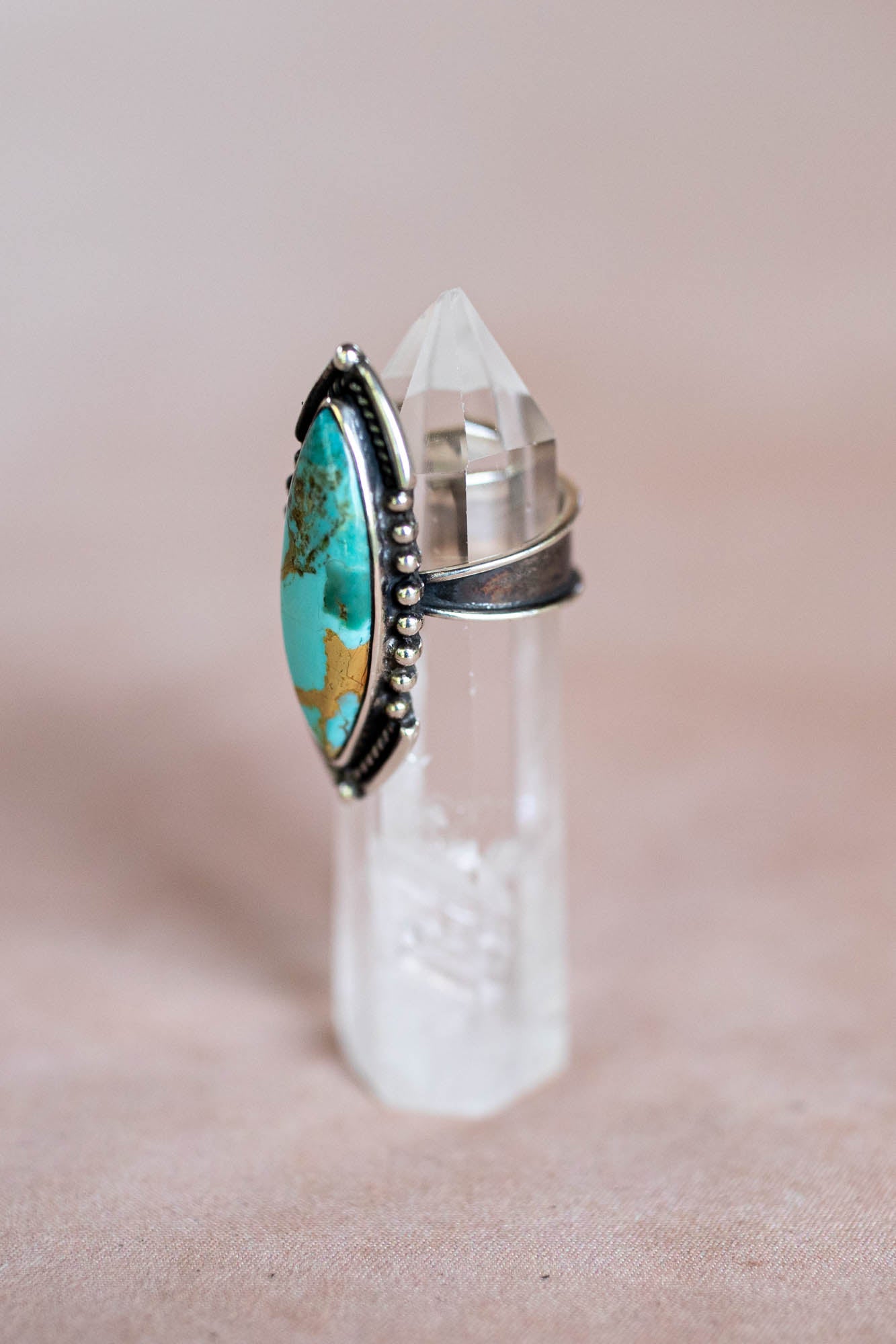 Turquoise stone ring on a clear crystal