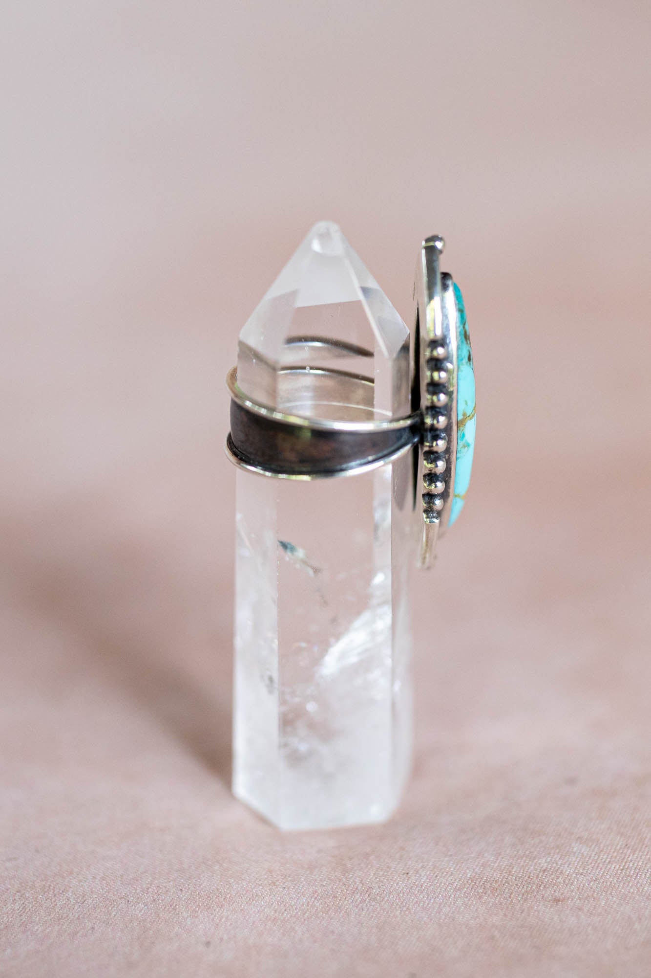 Clear crystal with silver ring and turquoise stone
