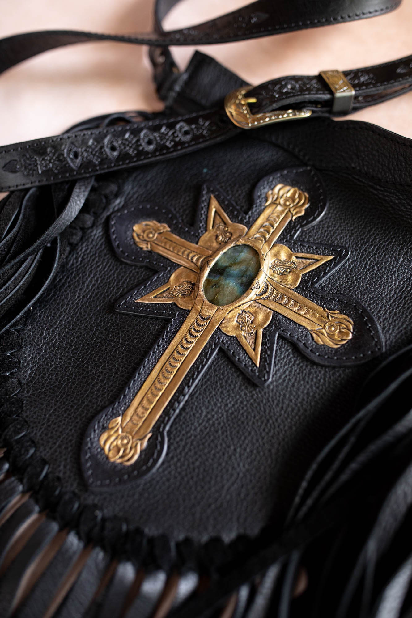 Black leather bag with gold cross and stone detail