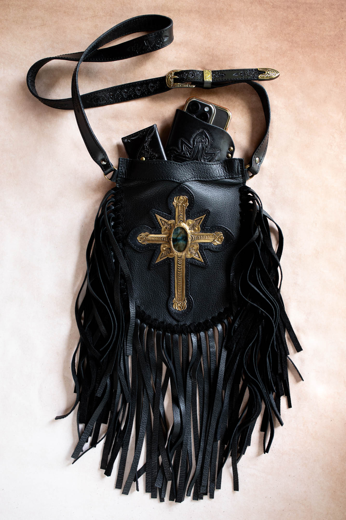 Black leather bag with gold cross and fringe 