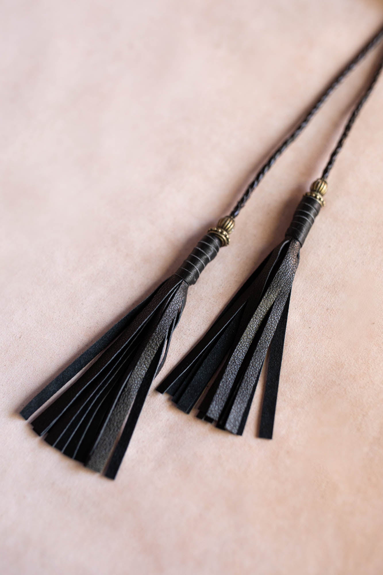 Black tassels on a beige background